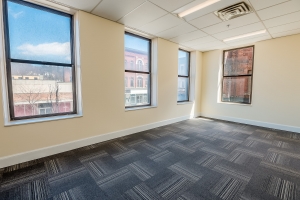office room with large windows and carpet floor