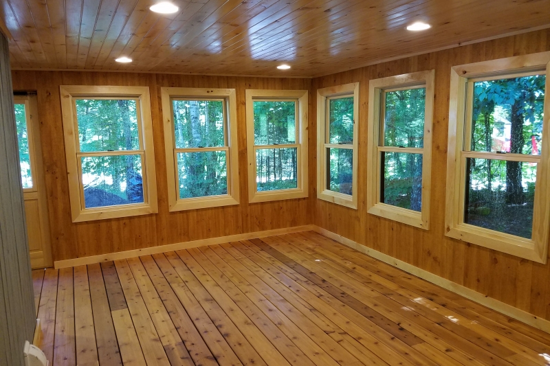 wooden sunroom with many windows