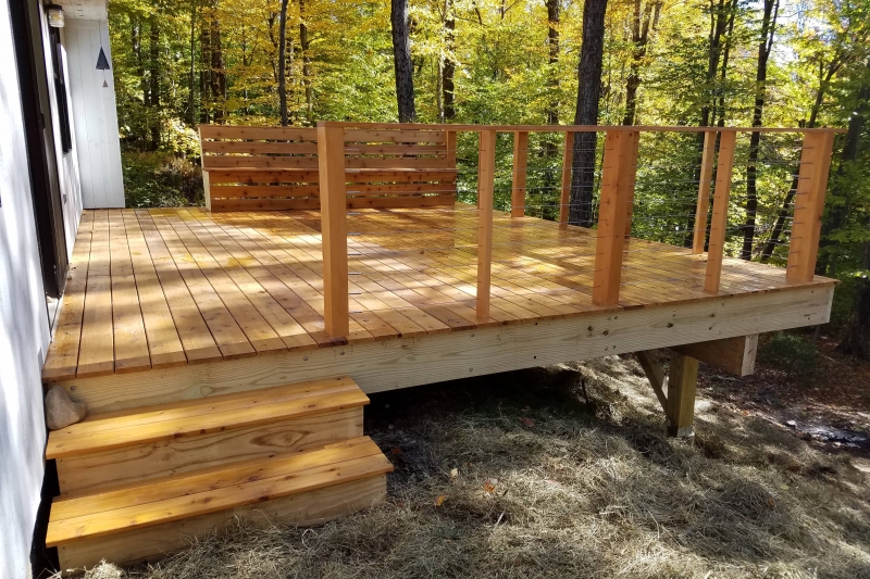 wooden deck with trees in background